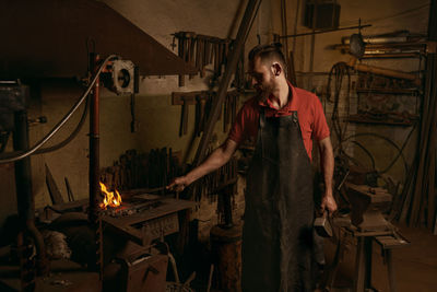 Blacksmith working at workshop