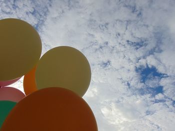 Low angle view of balloons against sky