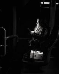 Woman sitting in mirror