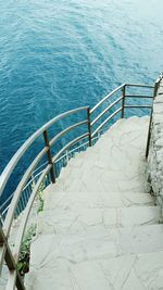 High angle view of stairs by sea