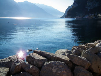 Scenic view of sea and mountains against sky