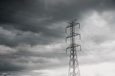 Low angle view of electricity pylon against sky
