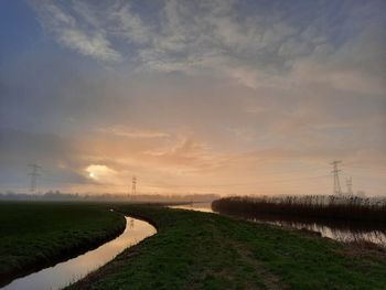 Scenic view of field against sky during sunset