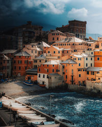 Townscape by sea against sky