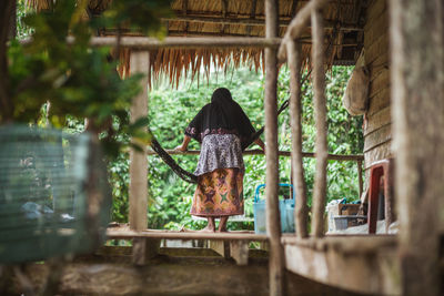 Rear view of woman against built structure