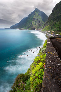 Scenic view of sea and mountains against sky