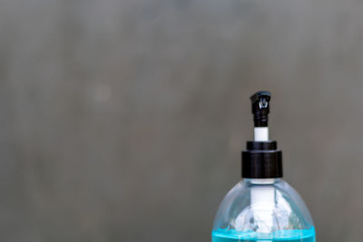 Close-up of bottle against wall