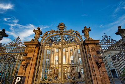 Low angle view of statues on building against sky