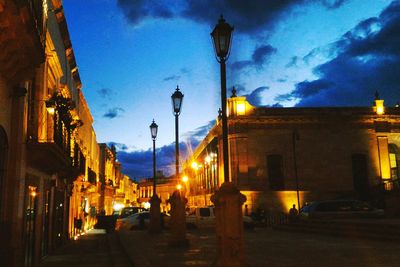 View of illuminated street lights at night