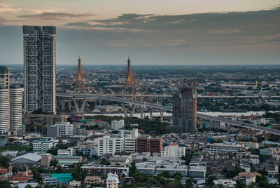 Buildings in city against sky during sunset