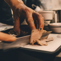 Close-up of man preparing food