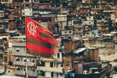 Close-up of flag against buildings in city