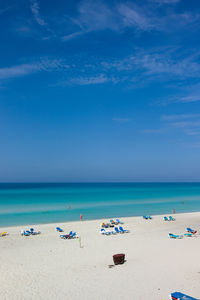 Scenic view of beach against blue sky