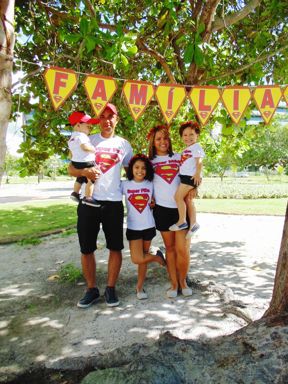 full length, happiness, friendship, looking at camera, togetherness, portrait, confidence, standing, people, carefree, tree, fun, bonding, outdoors, day, community, childhood, unity, teamwork, adult