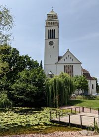 View of trees and building against sky