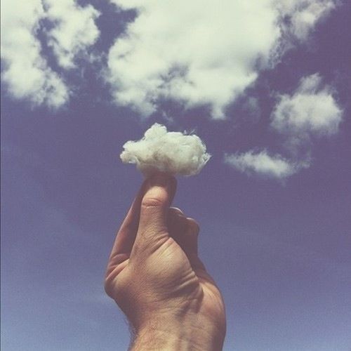 low angle view, sky, holding, person, blue, cloud - sky, human representation, part of, statue, white color, sculpture, cloud, day, nature, creativity, art and craft, outdoors