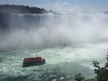 Scenic view of waterfall in sea