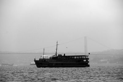 Black vintage ferry is sailing on the bosphorus sea