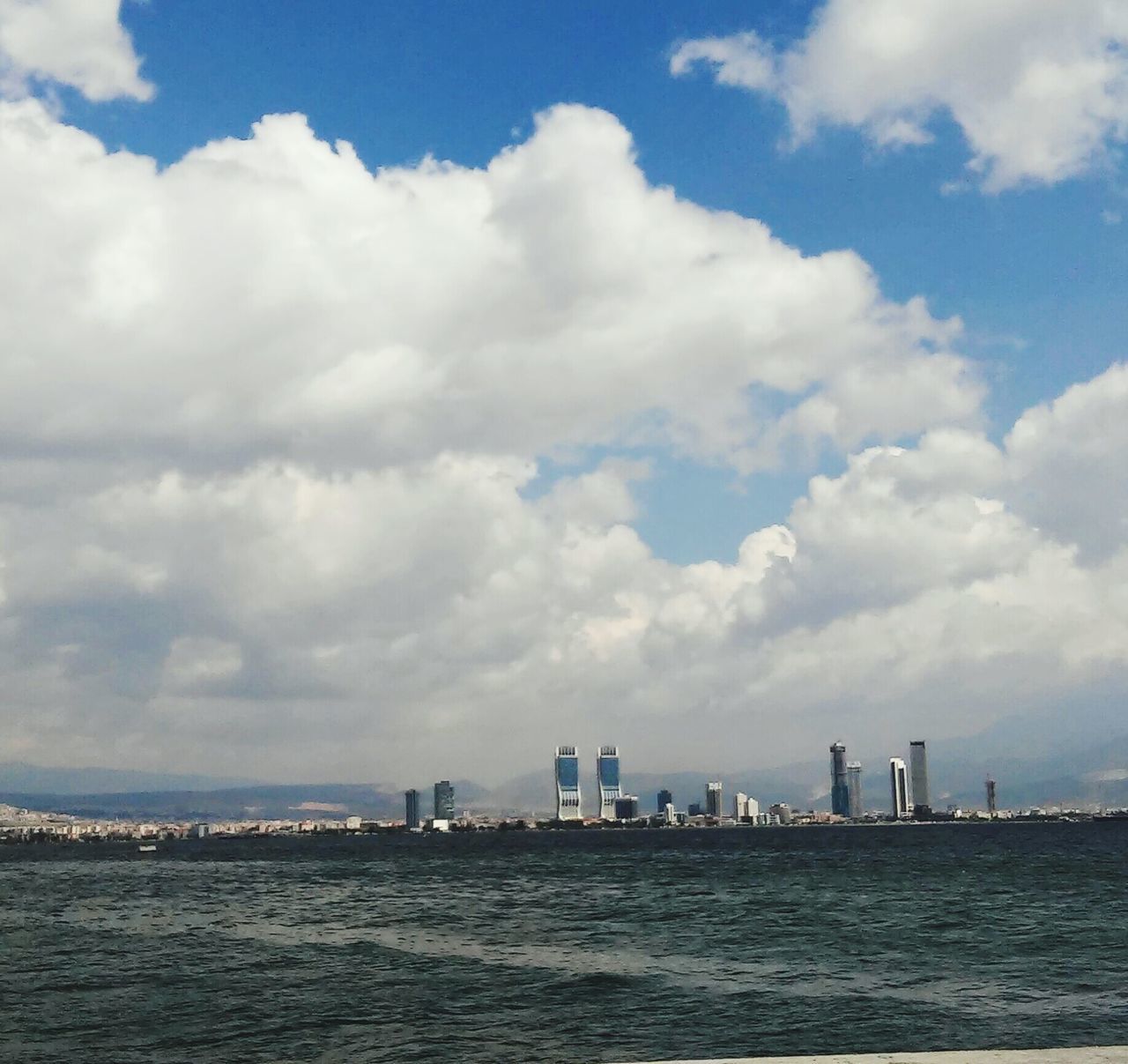 CITYSCAPE AGAINST CLOUDY SKY