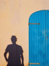 Rear view of man standing on wall