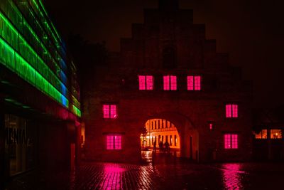 Illuminated building against sky at night