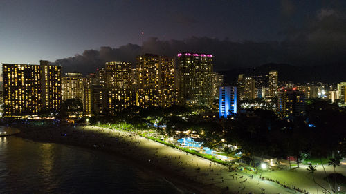 High angle view of illuminated buildings in city at night