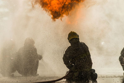 Rear view of people on fire in water