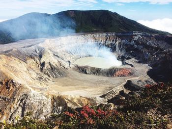 Aerial view of volcanic crater against sky