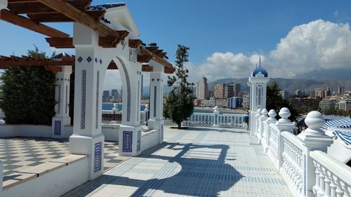 View of cityscape against cloudy sky