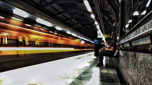 Blurred motion of train at railroad station