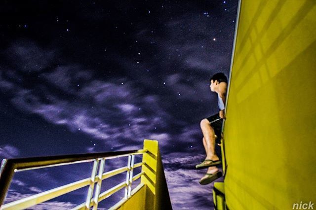 WOMAN STANDING AT NIGHT