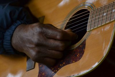 Close-up of man playing guitar