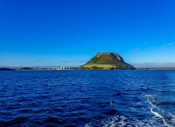 Scenic view of sea against clear blue sky