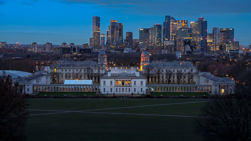 Illuminated buildings in city at dusk