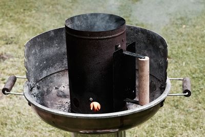 Smoke emitting from metal container on barbecue