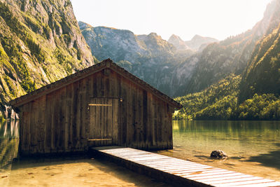 House by lake against mountains