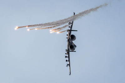 Low angle view of airplane flying against clear sky