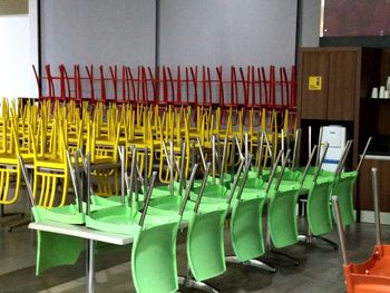 Empty chairs arranged in row