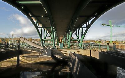 View of bridge in city against sky