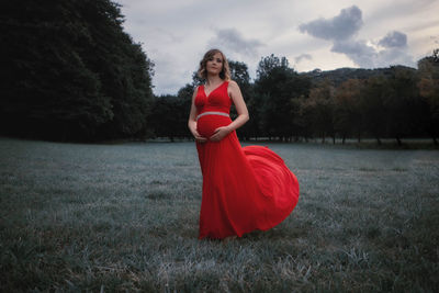 Pregnant woman standing on grass