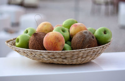 Close-up of apples in basket on table
