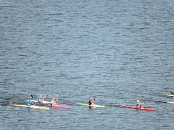 High angle view of people kayaking on sea