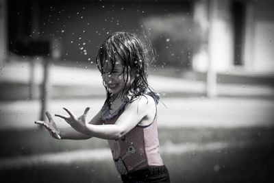 Full length of girl standing on wet rainy day