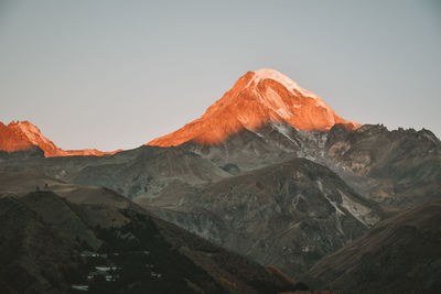 Scenic view of snowcapped mountains against clear sky