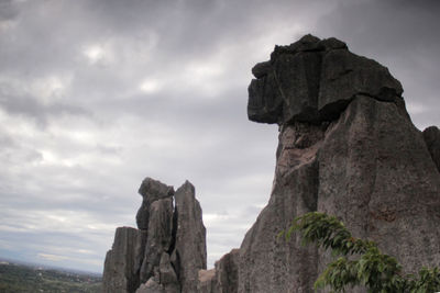 Low angle view of rock formation against sky