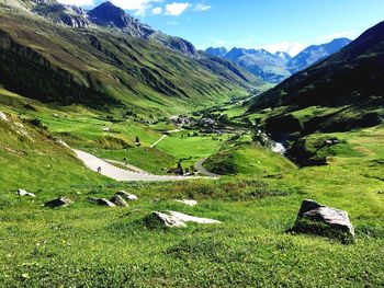 Scenic view of field and mountains against sky