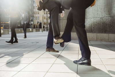 Business people greeting with feet during pandemic