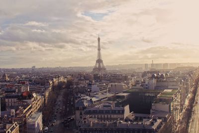 High angle view of city buildings against cloudy sky