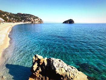 Scenic view of sea against clear blue sky