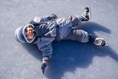 High angle view of boy standing on snow